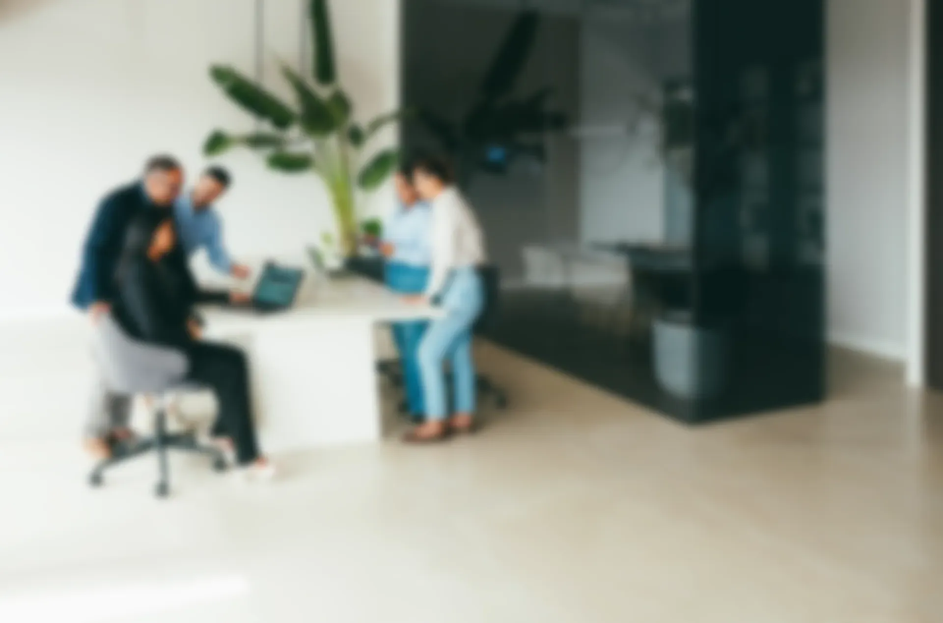 A multigenerational team in a meeting, softly out of focus